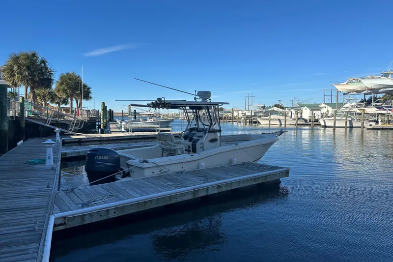 Slide: The Image of 2004 Scout 235 Sportfish boat docked at marina with clear blue sky. - 5