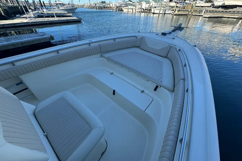 Slide: The Image of 2004 Scout 235 Sportfish boat with spacious seating, docked at a marina. - 9