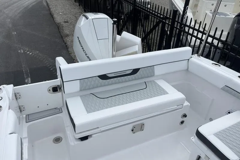 Slide: The Image of 2024 Blackfin 232 DC boat interior with white seating and Mercury outboard engine. - 11