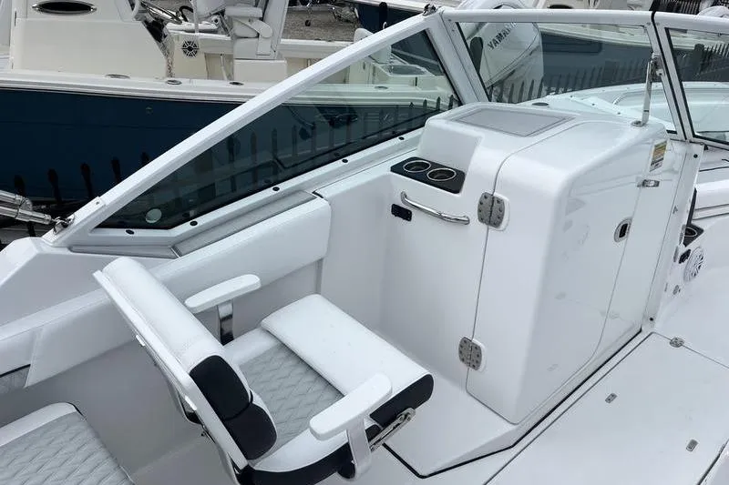 Slide: The Image of 2024 Blackfin 232 DC boat interior with white seating and console. - 15
