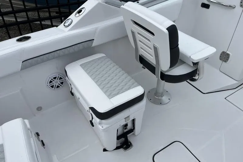 Slide: The Image of 2024 Blackfin 232 DC boat interior with cushioned seating and storage. - 18