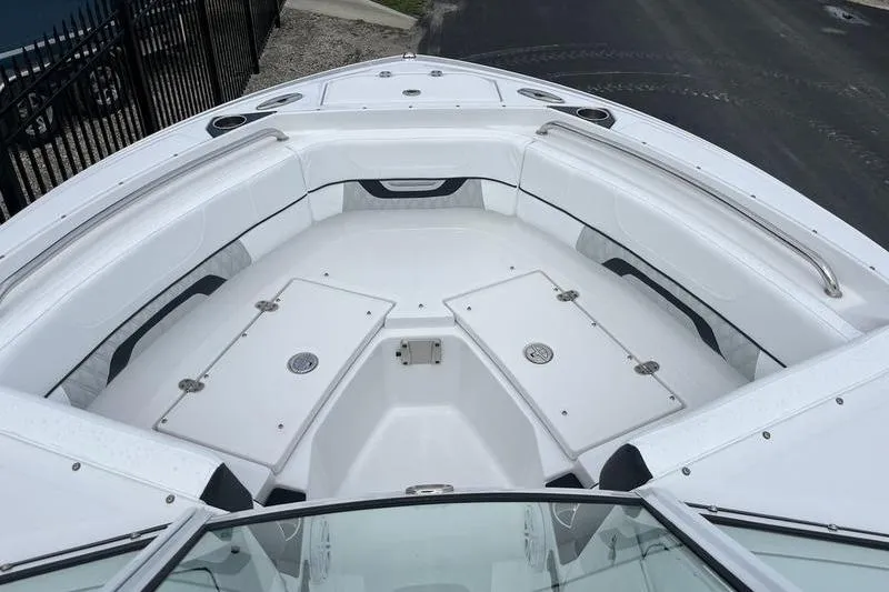 Slide: The Image of 2024 Blackfin 232 DC boat interior with white seating and storage compartments. - 6