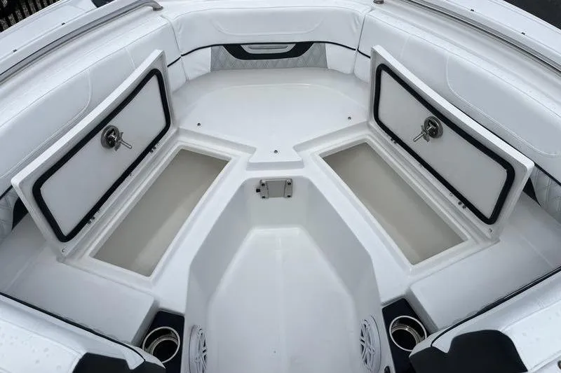 Slide: The Image of 2024 Blackfin 232 DC boat interior with open storage compartments and seating. - 7
