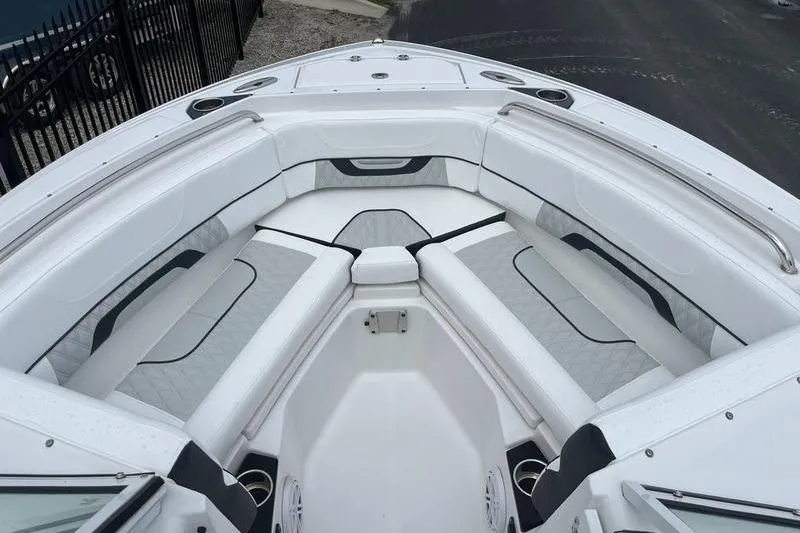 Slide: The Image of 2024 Blackfin 232 DC boat interior with white cushioned seating and sleek design. - 8