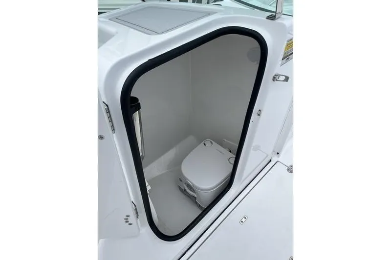 Slide: The Image of 2024 Blackfin 232 DC boat interior with compact marine toilet. - 9