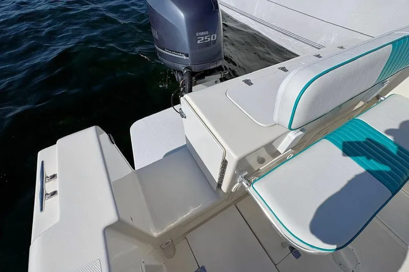 Slide: The Image of 2001 Bluewater 2350 boat interior with helm, seating, and controls on a sunny day. - 6