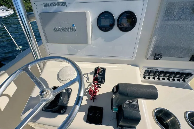 Slide: The Image of Control panel of a 2001 Bluewater 2350 boat with various switches. - 9