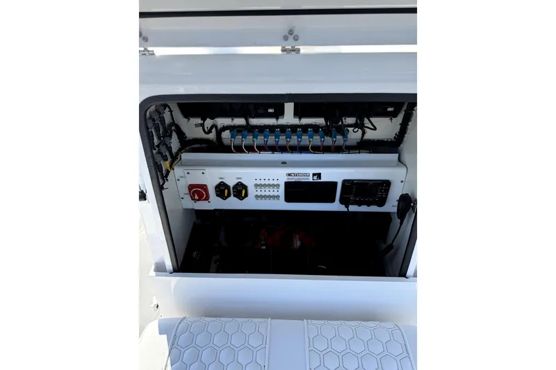 Slide: The Image of 2024 Contender 25 Bay boat storage compartment with speakers and open hatch. - 18