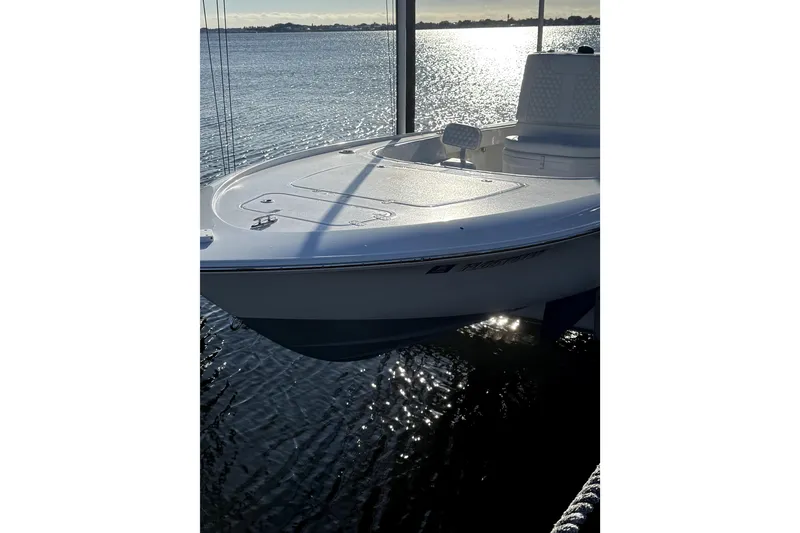 Slide: The Image of 2024 Contender 25 Bay boat docked on a sunny day by the water. - 4