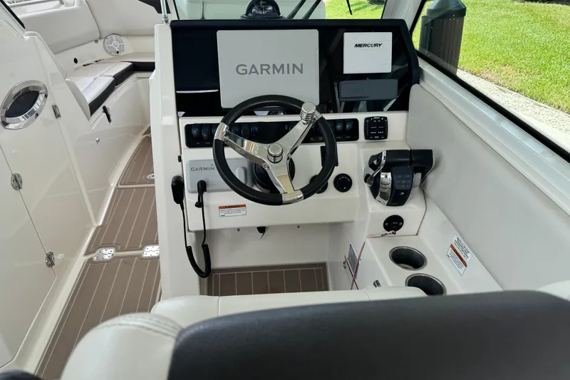 Slide: The Image of 2021 Sailfish 276 DC boat cockpit with Garmin and Mercury controls. - 10