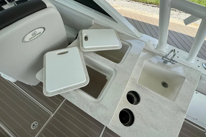 Slide: The Image of Sailfish 276 DC 2021 boat interior with cutting boards and sink area. - 14