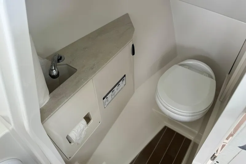 Slide: The Image of 2021 Sailfish 276 DC boat bathroom with toilet and sink. - 15
