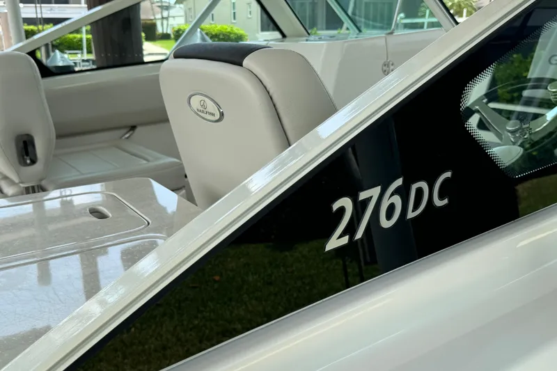 Slide: The Image of 2021 Sailfish 276 DC boat interior with seating and model branding. - 20