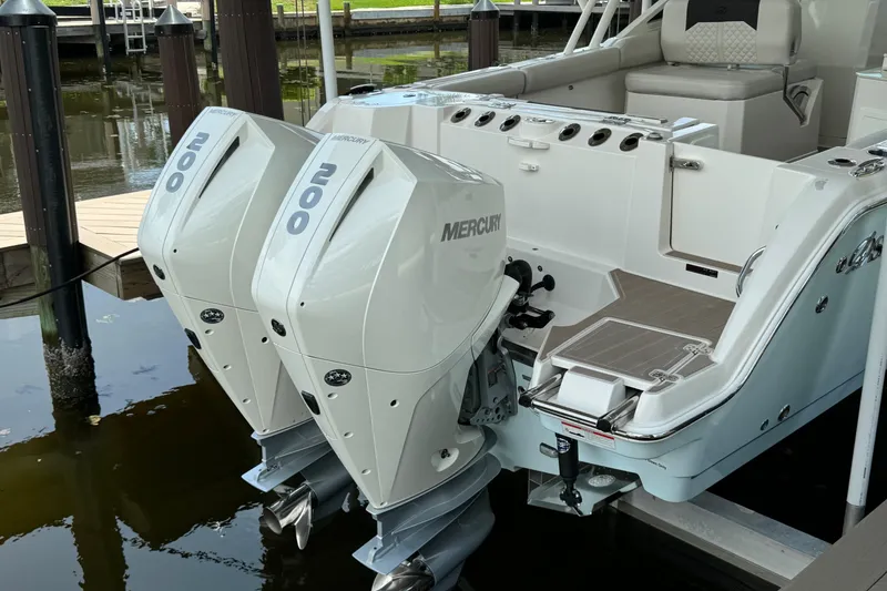Slide: The Image of 2021 Sailfish 276 DC boat with twin Mercury 200 engines docked at marina. - 5
