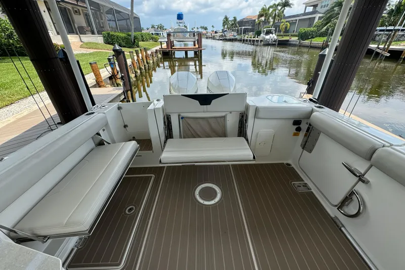 Slide: The Image of 2021 Sailfish 276 DC boat interior with seating and water view. - 7