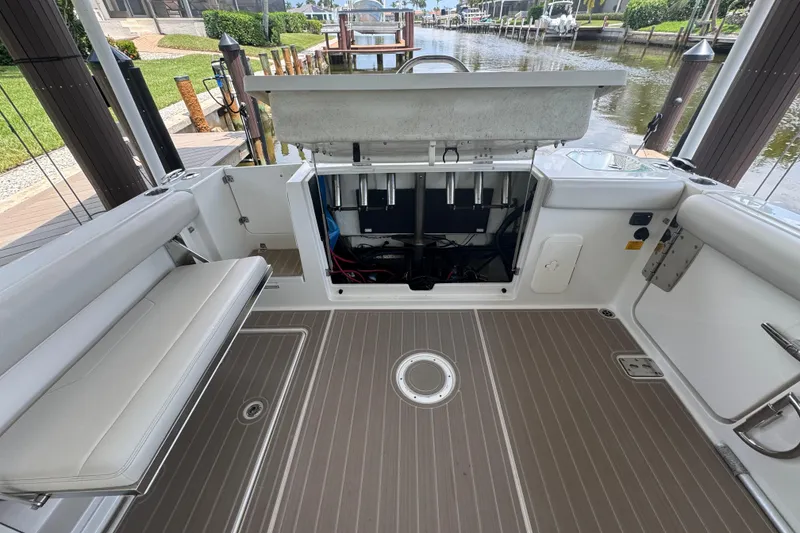 Slide: The Image of 2021 Sailfish 276 DC boat interior with open storage compartment and seating. - 8