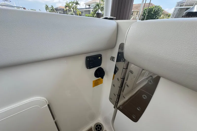 Slide: The Image of Interior view of 2021 Sailfish 276 DC boat, featuring white seating and control panel. - 9