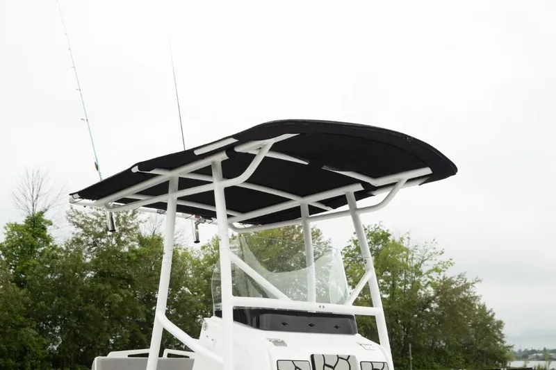 Slide: The Image of 2025 Wellcraft 202 Fisherman boat with T-top against a cloudy sky. - 21