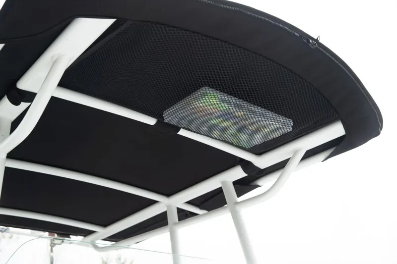 Slide: The Image of 2025 Wellcraft 202 Fisherman boat canopy with netted storage compartment. - 24