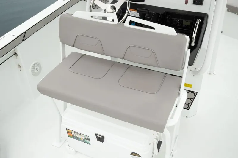 Slide: The Image of 2025 Wellcraft 202 Fisherman boat interior with cushioned seating and steering console. - 5