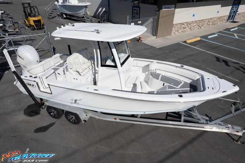 Slide: The Image of 2022 Sea Hunt Ultra 239 SE boat on trailer in marina parking lot. - 10