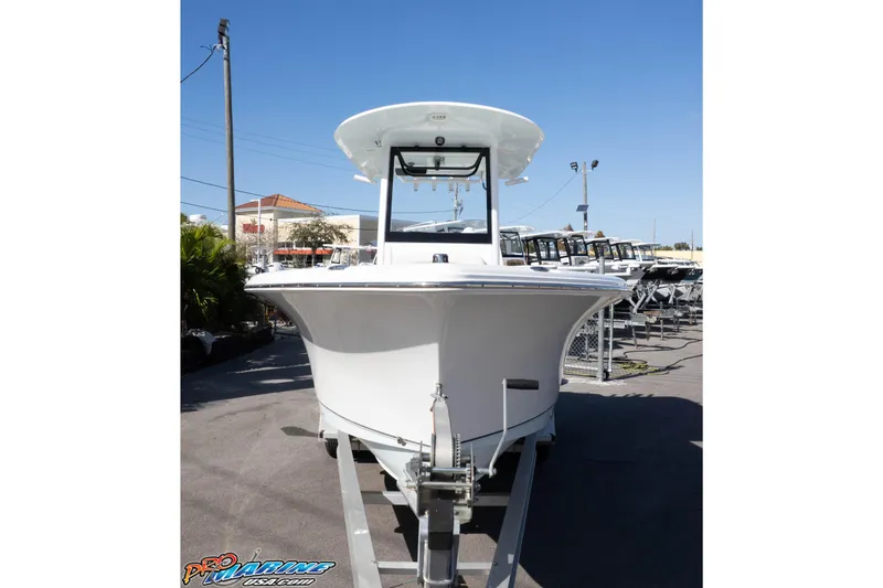 Slide: The Image of 2022 Sea Hunt Ultra 239 SE boat on trailer, displayed outdoors under clear blue sky. - 12