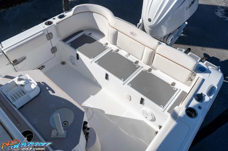 Slide: The Image of 2022 Sea Hunt Ultra 239 SE boat interior with seating and storage compartments. - 18