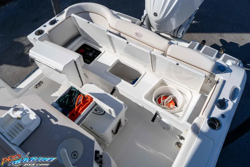 Slide: The Image of 2022 Sea Hunt Ultra 239 SE boat interior with storage compartments and equipment. - 19