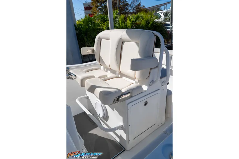 Slide: The Image of 2022 Sea Hunt Ultra 239 SE boat seating with white cushioned seats and armrests. - 22