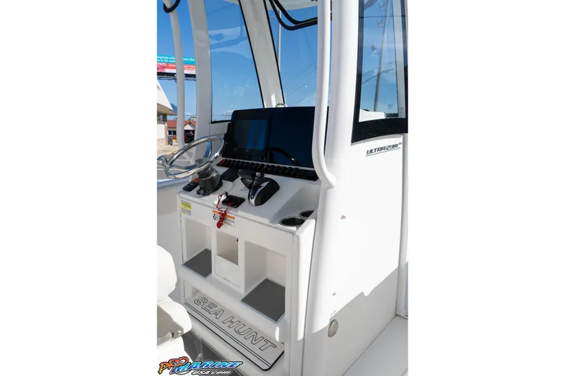 Slide: The Image of 2022 Sea Hunt Ultra 239 SE boat console with steering wheel and controls. - 23
