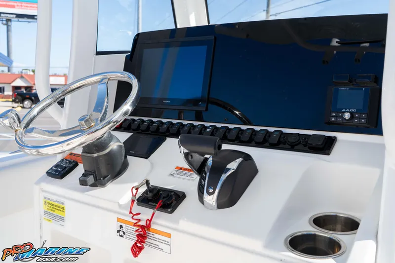 Slide: The Image of 2022 Sea Hunt Ultra 239 SE boat dashboard with steering wheel and controls. - 26