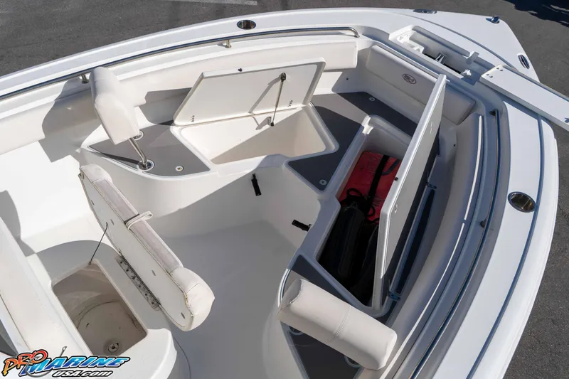 Slide: The Image of 2022 Sea Hunt Ultra 239 SE boat interior with open storage compartments and seating. - 28