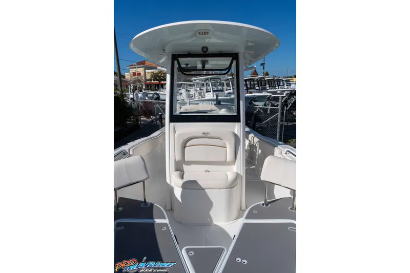 Slide: The Image of 2022 Sea Hunt Ultra 239 SE boat interior with seating and console, displayed outdoors. - 29