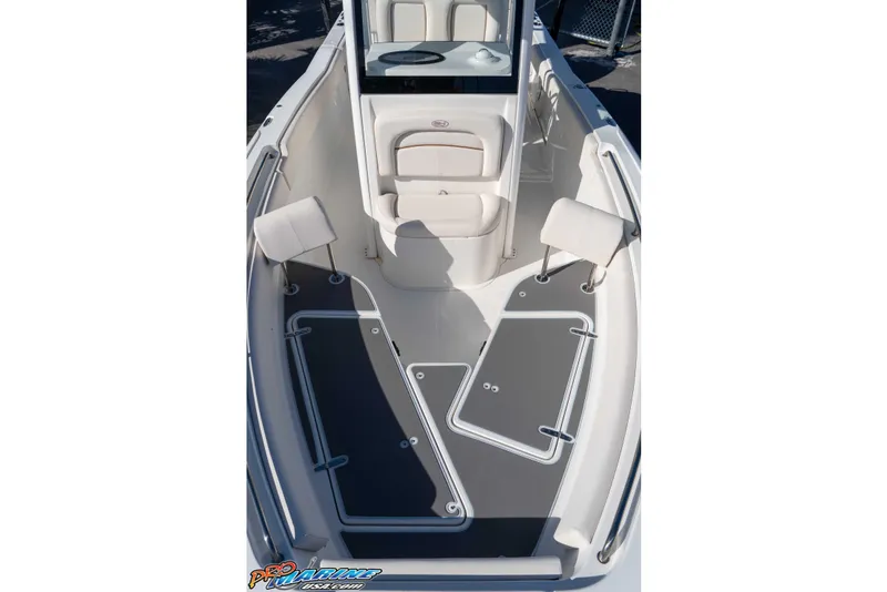 Slide: The Image of 2022 Sea Hunt Ultra 239 SE boat interior with cushioned seating and non-slip flooring. - 30
