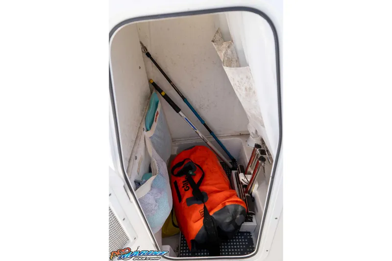 Slide: The Image of Storage compartment in a 2022 Sea Hunt Ultra 239 SE boat with fishing gear and equipment. - 31