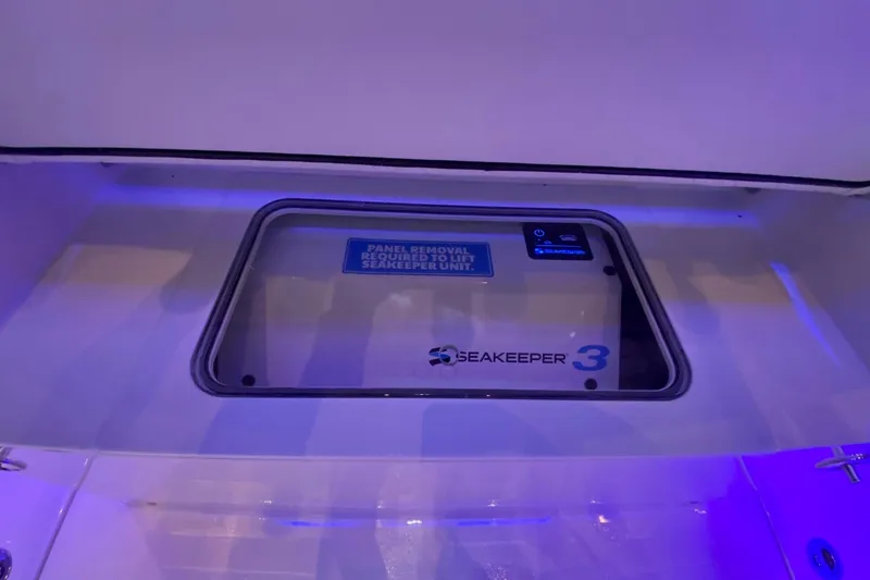 Slide: The Image of Seakeeper 3 stabilization system in 2026 Scout 357 LXF boat, illuminated in blue light. - 10