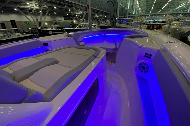 Slide: The Image of 2026 Scout 357 LXF boat interior with blue LED lighting and luxurious seating. - 14