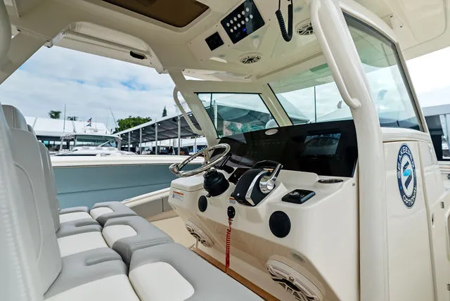 Slide: The Image of Control panel inside 2026 Scout 357 LXF boat cabin, featuring modern navigation equipment. - 24