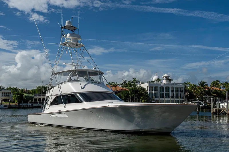 The Image of 2007 Viking 64 Convertible yacht on calm water with luxury waterfront homes in the background. - 0