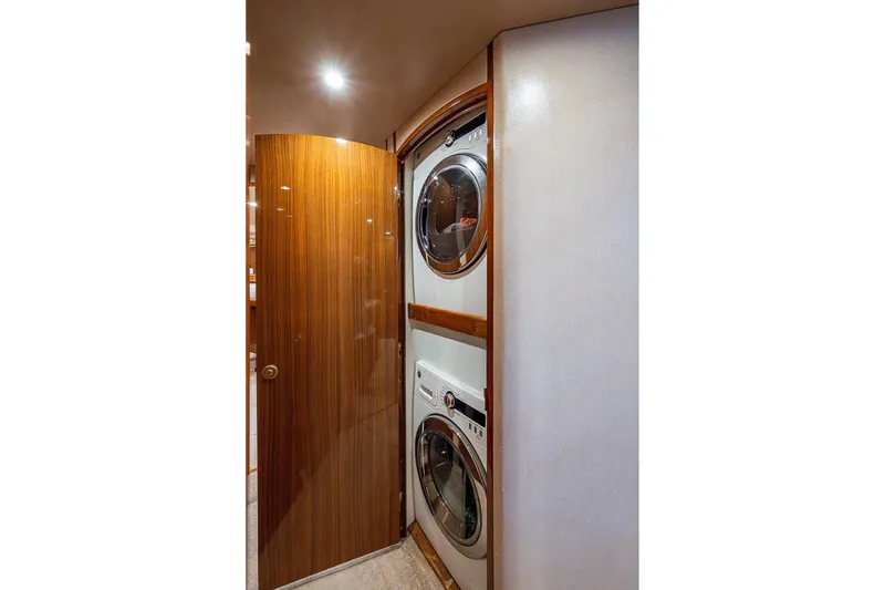 Slide: The Image of Laundry area in 2007 Viking 64 Convertible yacht with stacked washer and dryer. - 15