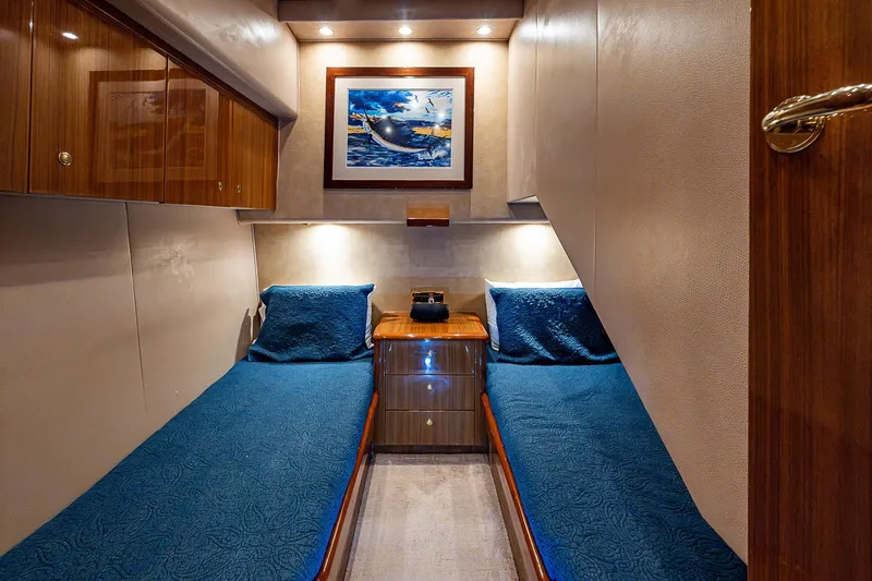 Slide: The Image of Luxurious 2007 Viking 64 Convertible yacht cabin with twin beds and elegant decor. - 18