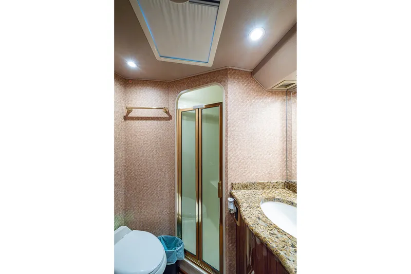 Slide: The Image of Luxurious bathroom in 2007 Viking 64 Convertible yacht with granite countertop and shower. - 23