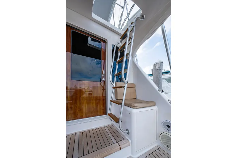 Slide: The Image of Staircase and seating area on 2007 Viking 64 Convertible yacht. - 27