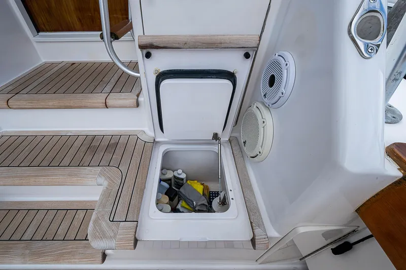 Slide: The Image of Storage compartment on 2007 Viking 64 Convertible yacht with teak flooring and marine speakers. - 28
