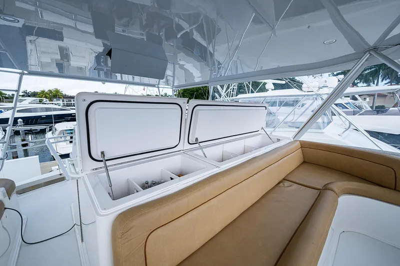 Slide: The Image of 2007 Viking 64 Convertible yacht interior with open storage compartments and tan seating. - 39