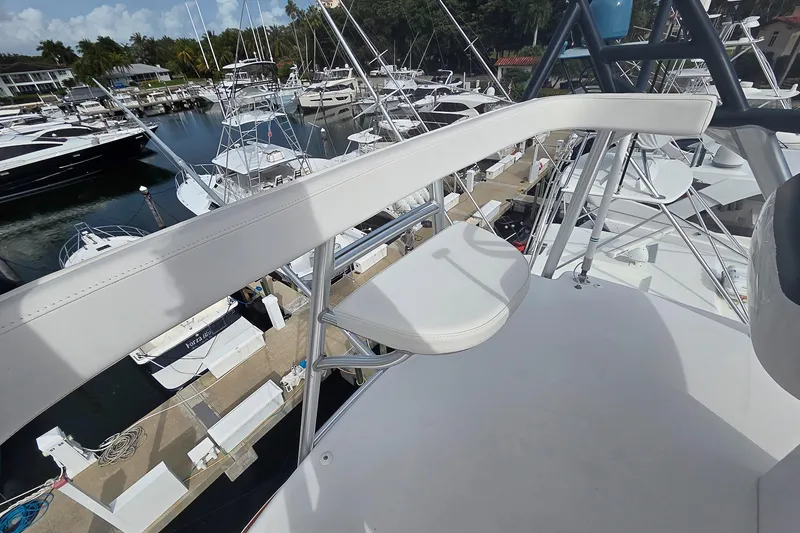 Slide: The Image of 2007 Viking 64 Convertible yacht overlooking marina with multiple boats docked. - 41