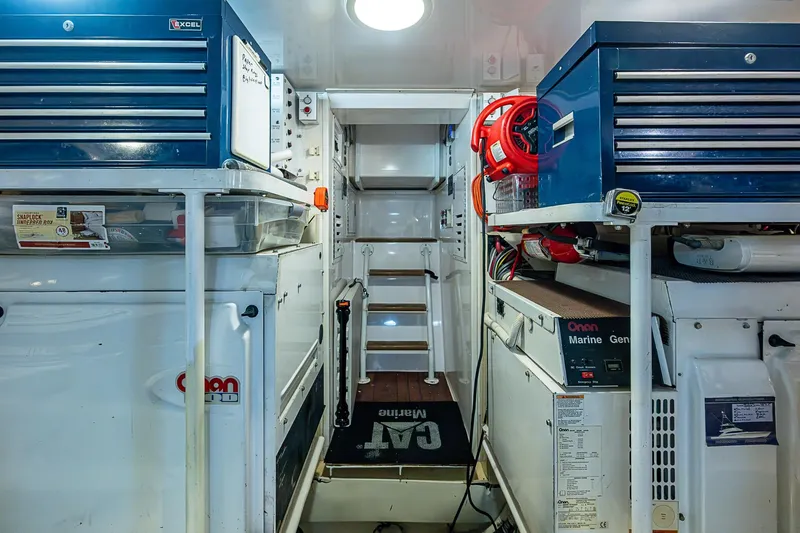 Slide: The Image of Engine room of 2007 Viking 64 Convertible yacht with toolboxes and equipment. - 43