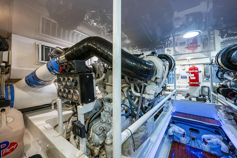 Slide: The Image of Engine room of a 2007 Viking 64 Convertible yacht, featuring complex machinery and gauges. - 46