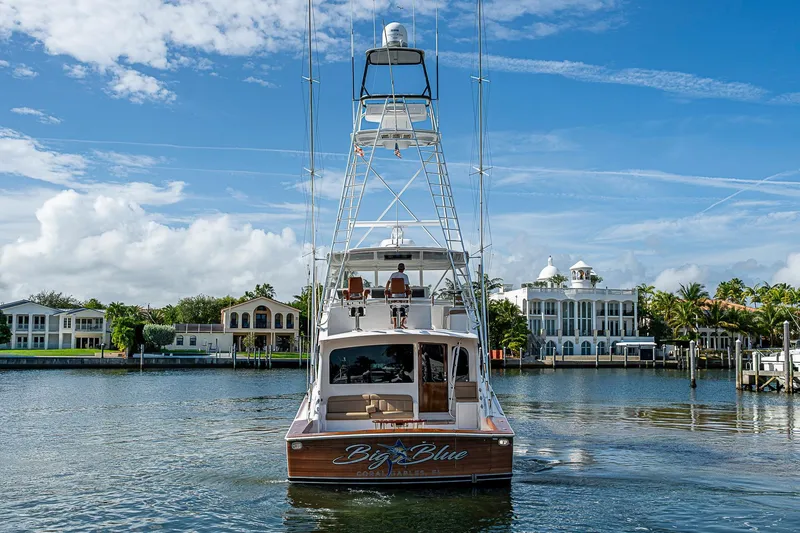 Slide: The Image of 2007 Viking 64 Convertible yacht on a scenic waterfront with luxury homes. - 8