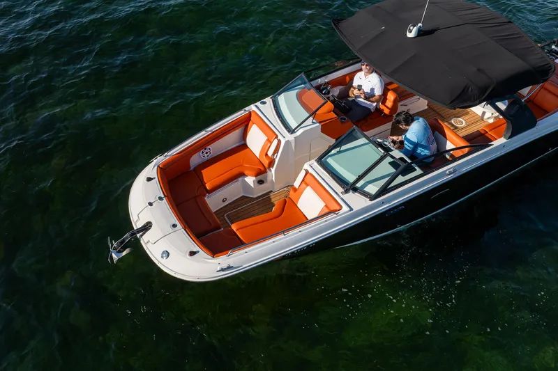Slide: The Image of 2019 Sea Ray SDX 290 Outboard boat with orange seating on clear water. - 11